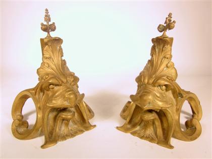 Appraisal: Pair of bronze chenetsGilt patina cast as masks in the