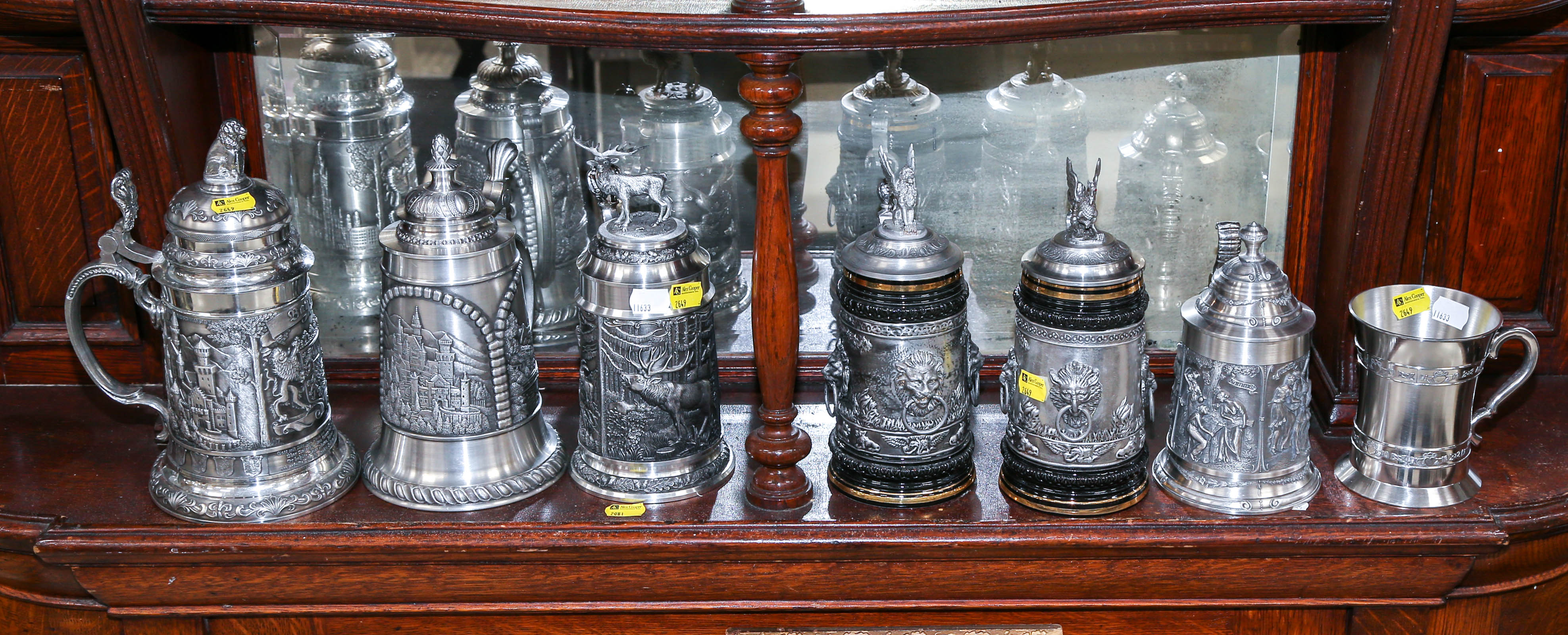 Appraisal: SIX ORNATE GERMAN PEWTER STEINS PEWTER IRISH CUP Including six