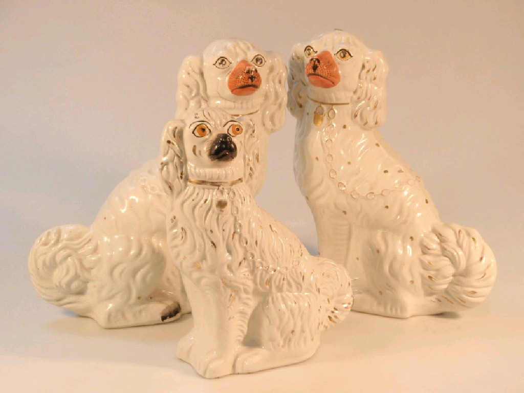 Appraisal: A pair of late thC Staffordshire pottery spaniels with painted