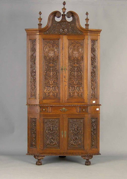 Appraisal: Pennsylvania heavily carved oak corner cupboard ca in parts with