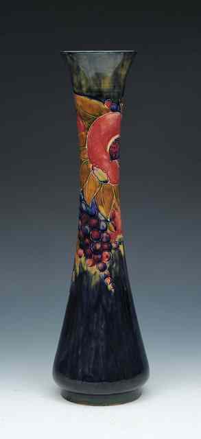 Appraisal: A William Moorcroft 'Pomegranate' trumpet shaped vase circa - on