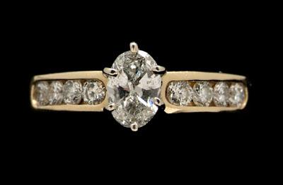 Appraisal: Lady's gold diamond ring central oval brilliant-cut diamond estimated weight