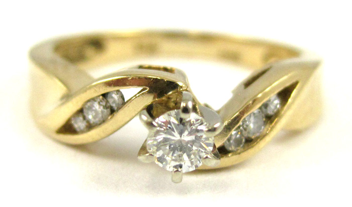 Appraisal: DIAMOND AND FOURTEEN KARAT GOLD RING with three round-cut diamonds