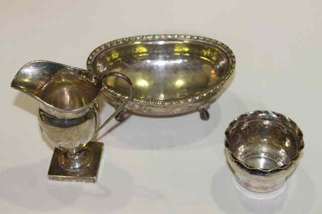 Appraisal: A GEORGIAN STYLE SILVER CREAM JUG on pedestal foot a