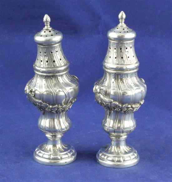 Appraisal: A pair of th century continental cast silver sugar casters