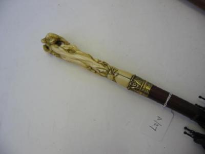 Appraisal: A LATE VICTORIAN UMBRELLA the ivory handle carved pierced and