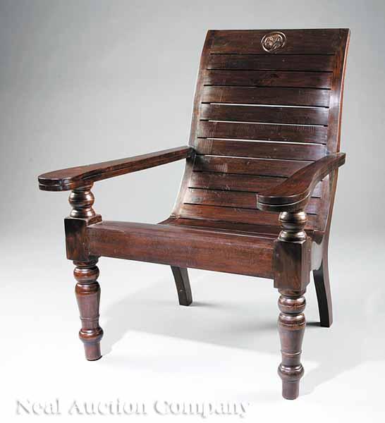 Appraisal: A Carved Teakwood or Tropical Hardwood Planter's Armchair in the