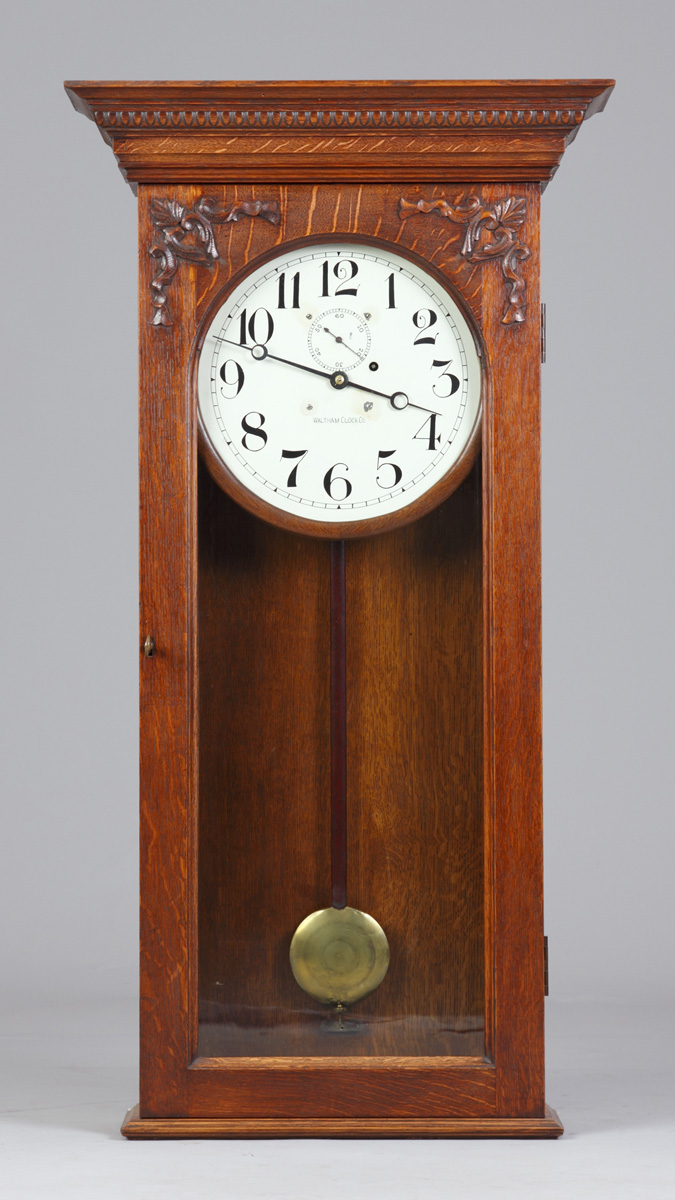 Appraisal: Waltham Clock Co Wall Regulator Oak case with applied carvings