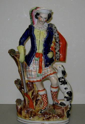 Appraisal: STAFFORDSHIRE POTTERY SCOTTISH HUNTER FIGURE Standing by a tree with