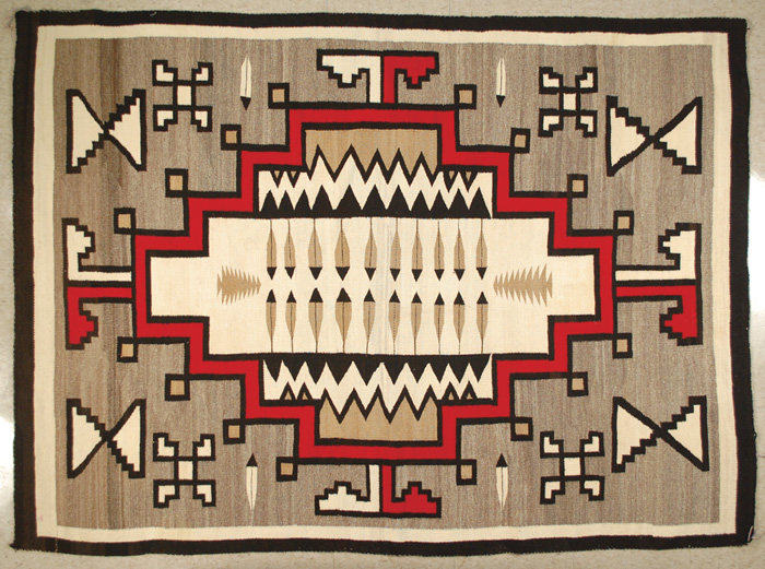 Appraisal: TWO GREY HILLS NAVAJO RUG centering a rectangular feather-filled ivory