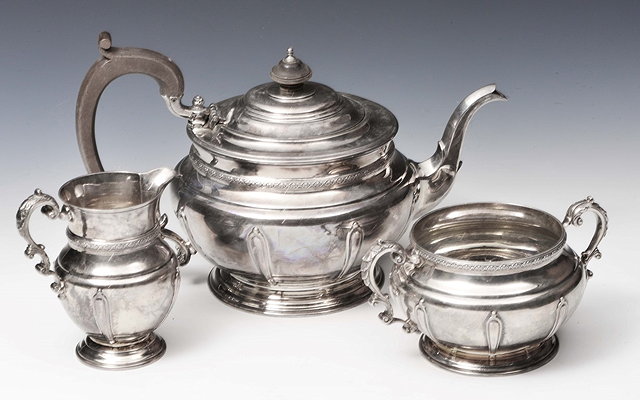 Appraisal: A SILVER THREE PIECE TEA SET circular teapot with fluted