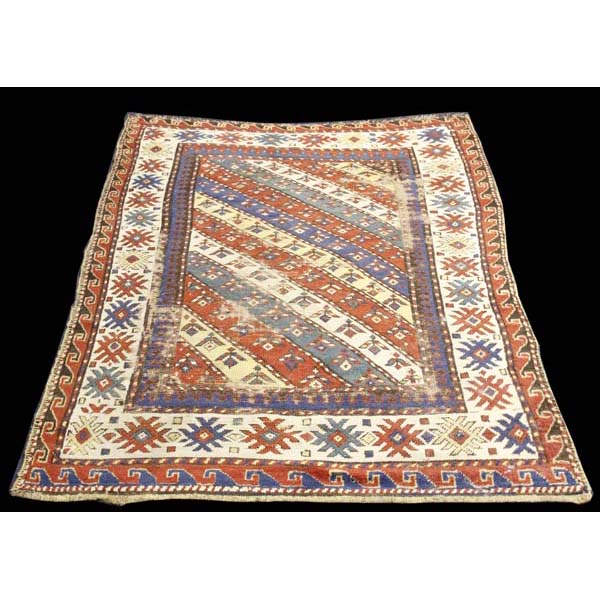 Appraisal: Caucasian wool area rug carpet x Features a field of