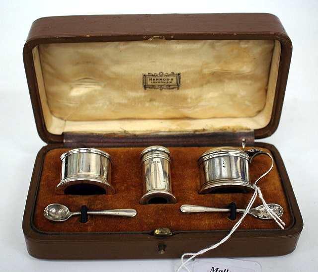 Appraisal: A SILVER CRUET SET with blue glass lining in a