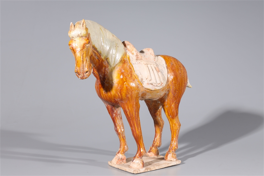 Appraisal: Chinese Tang dynasty glazed pottery horse and saddle glaze flaws