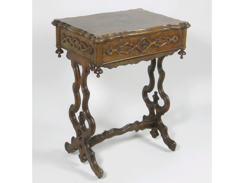 Appraisal: A walnut Sewing Table with hinged top on cheval frame