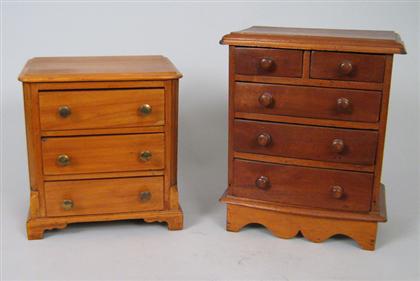 Appraisal: Two miniature chests of drawers The larger a bow front