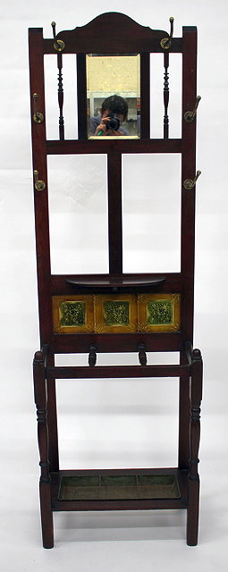 Appraisal: A MAHOGANY HALL STAND with brass hooks bevelled mirror plate