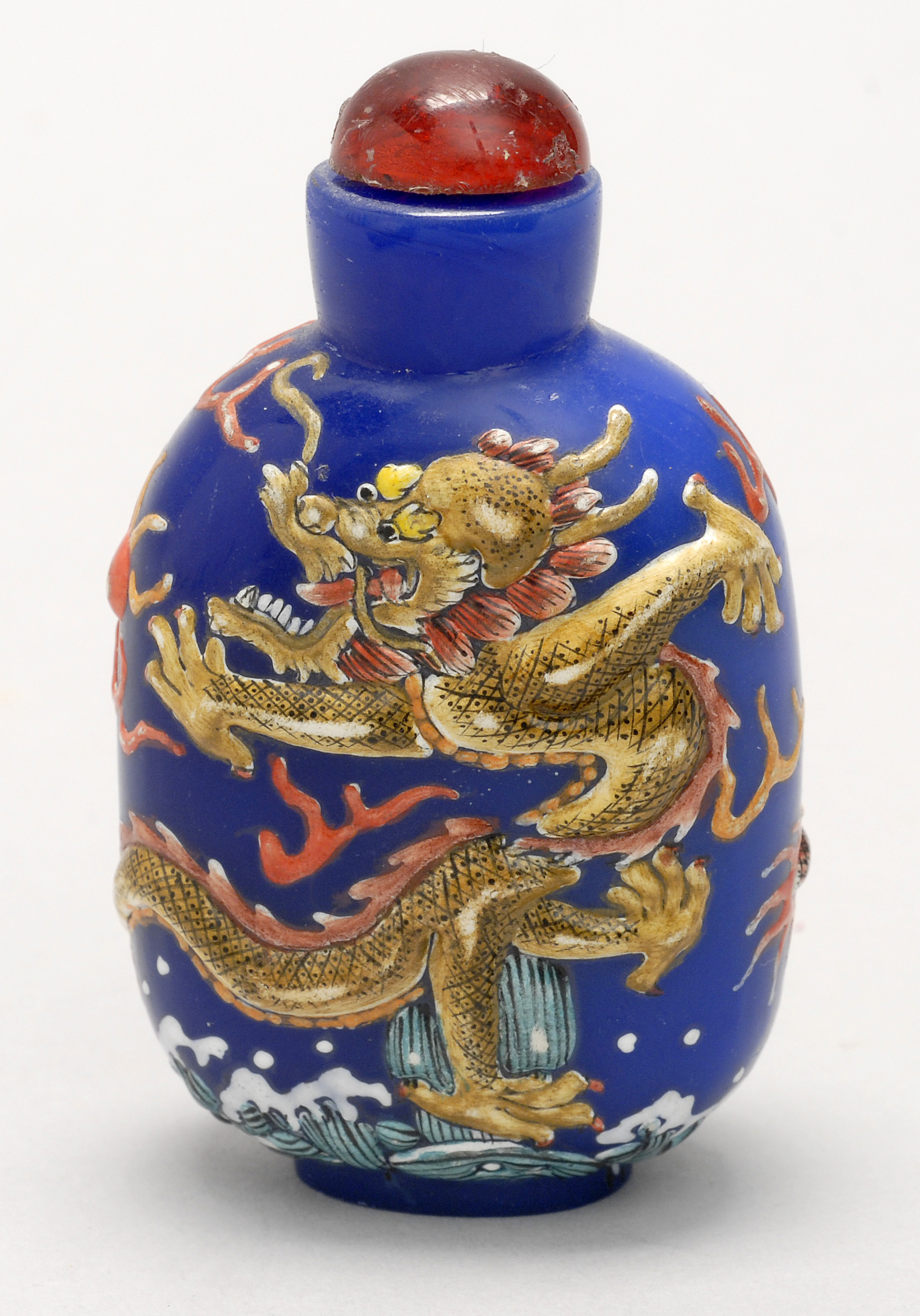 Appraisal: UNUSUAL ENAMEL-ON-BLUE GLASS SNUFF BOTTLE th CenturyIn elongated ovoid form