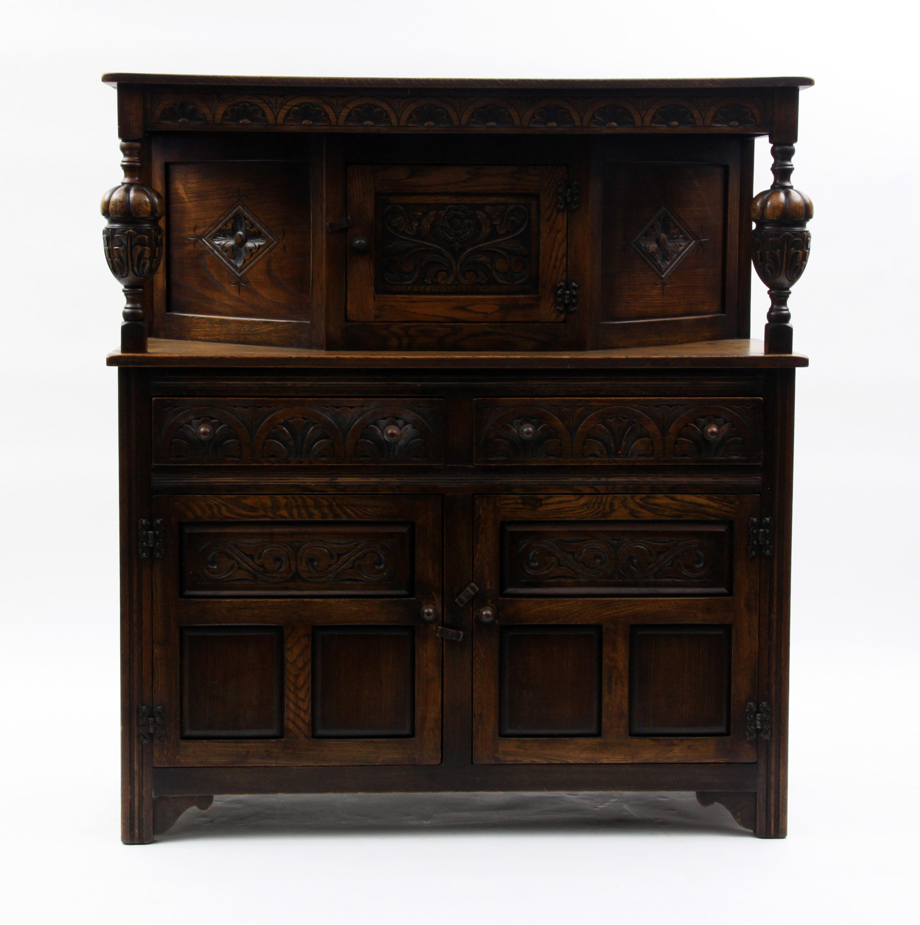 Appraisal: A carved oak court cupboard with bulbous pillars to the