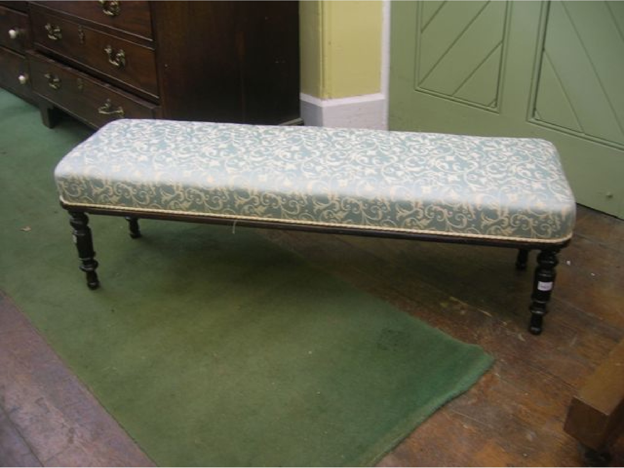 Appraisal: A window stool with rectangular upholstered seat raised on four