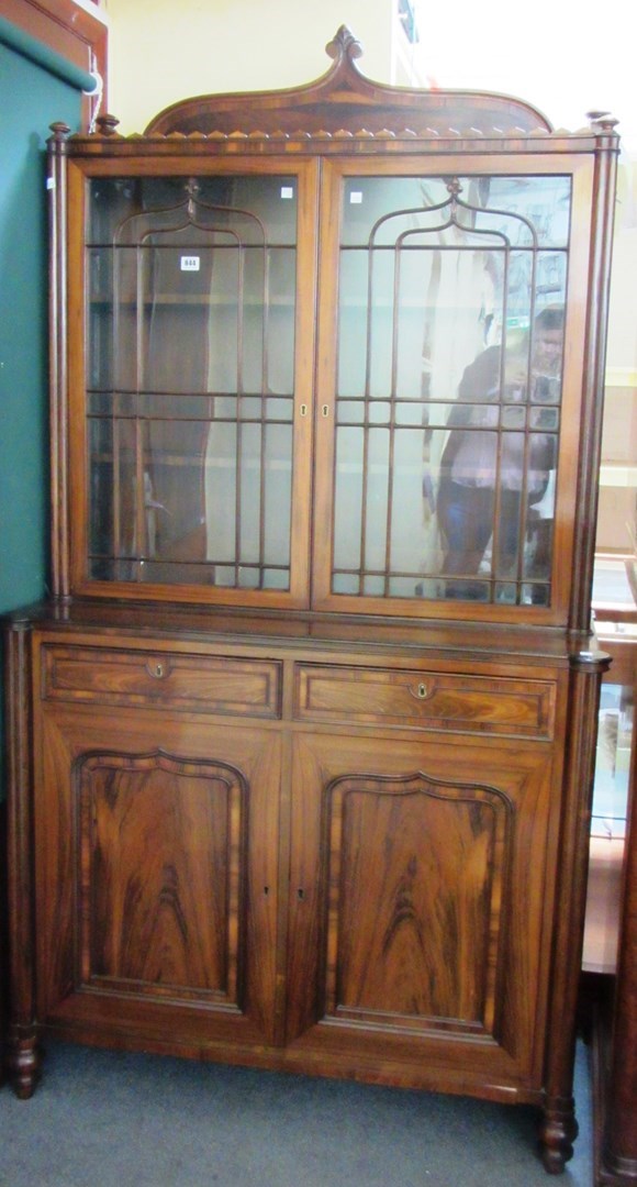 Appraisal: A Regency rosewood bookcase cupboard the pair of arched astragal