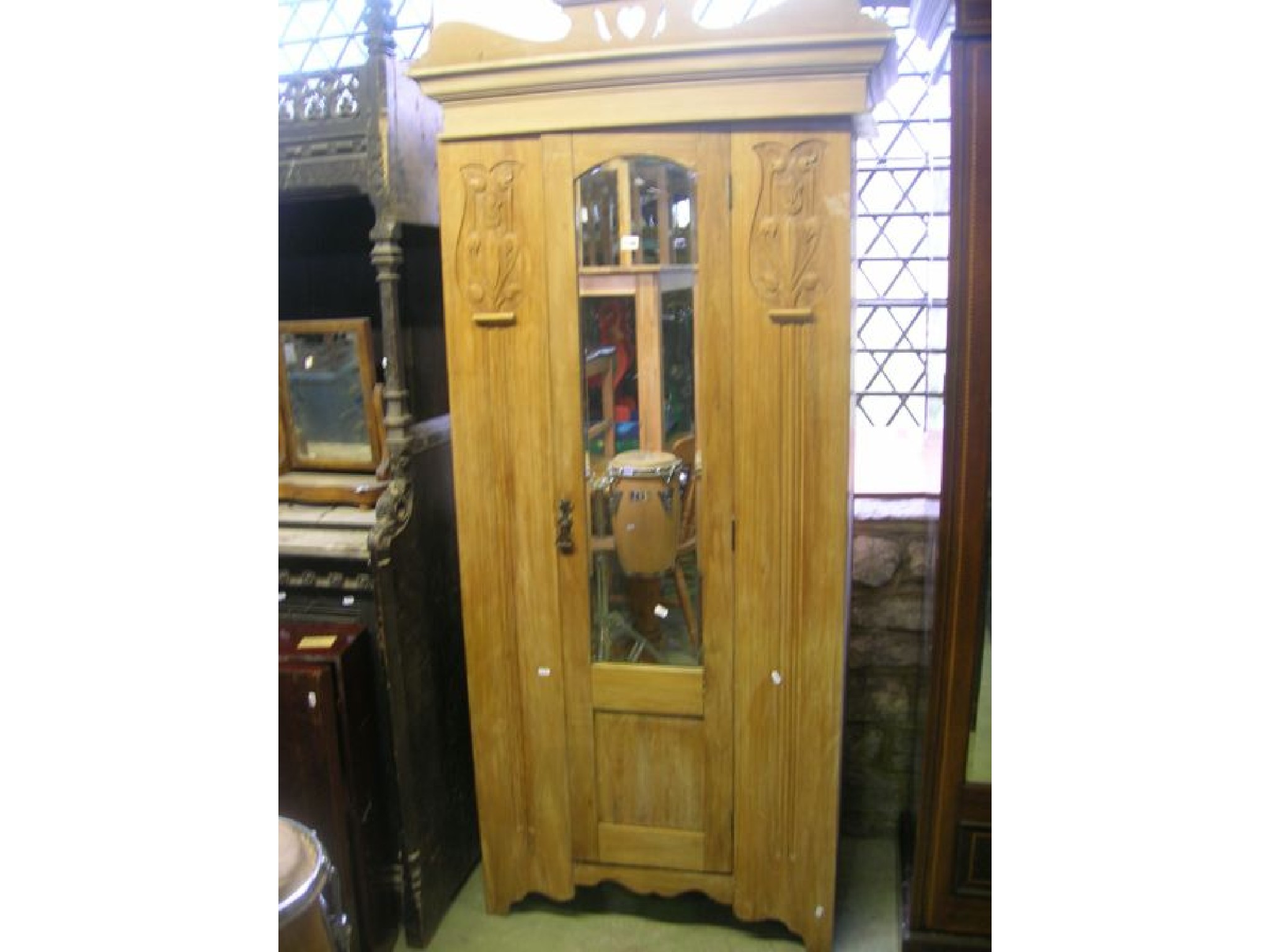 Appraisal: An Edwardian walnut single wardrobe enclosed by a central slender