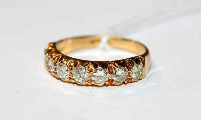 Appraisal: A SEVEN STONE DIAMOND SET HALF ETERNITY RING shank stamped