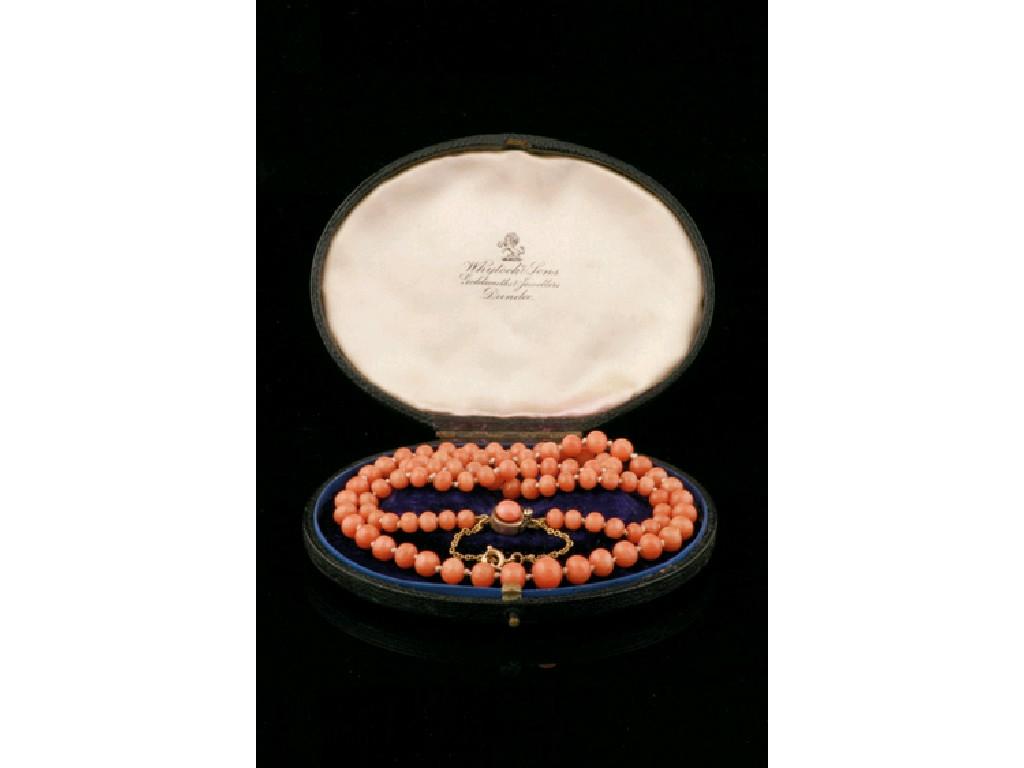 Appraisal: A ROW OF KNOTTED GRADUATED CORAL BEADS set on a