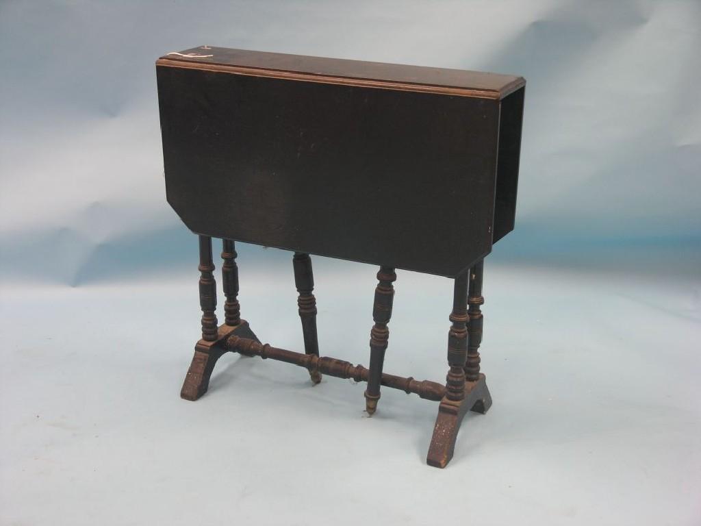 Appraisal: A Victorian ebonised wood Sutherland table on turned underframe with