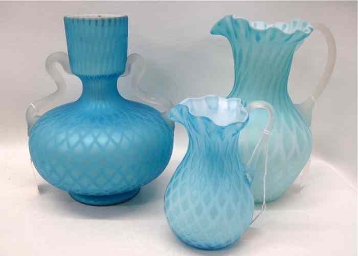 Appraisal: THREE SATIN GLASS QUILTED ART GLASS PIECES two pitchers and