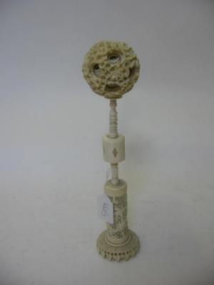 Appraisal: A CHINESE IVORY PUZZLE BALL ON STAND comprising ten pierced