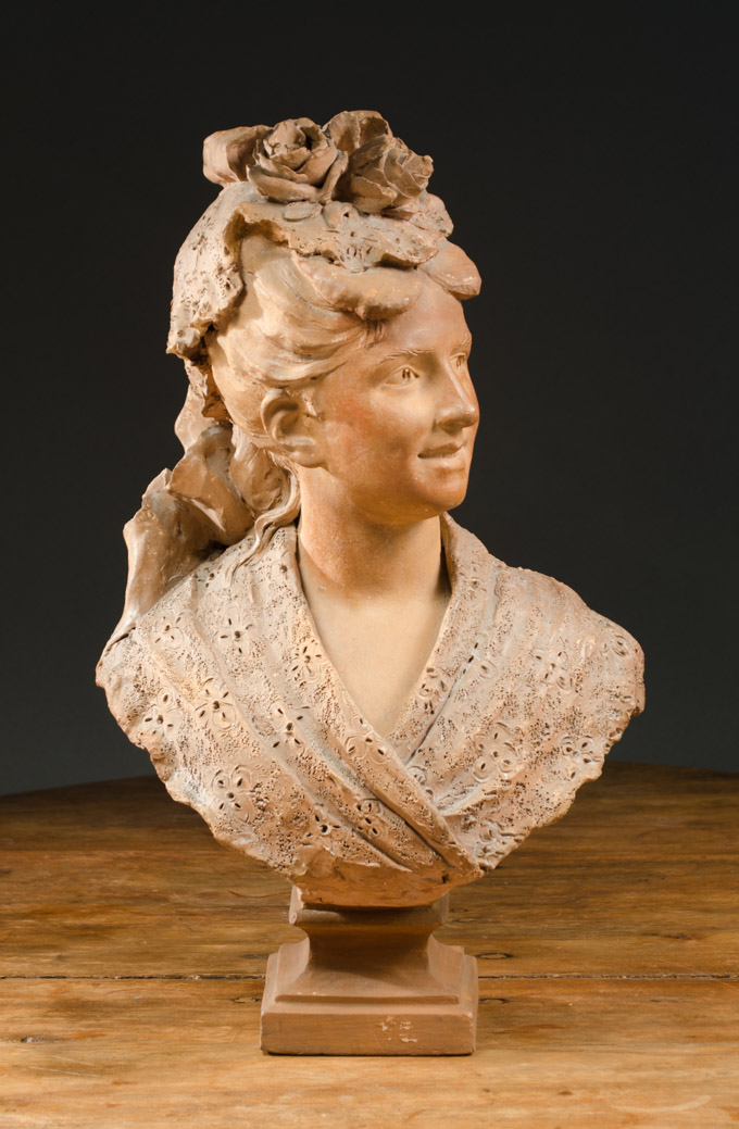 Appraisal: TERRACOTTA PORTRAIT BUST of a young Victorian lady with flowers