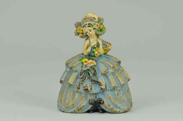 Appraisal: WOMAN IN RUFFLED SKIRT DOORSTOP Greatly detailed molding of blue