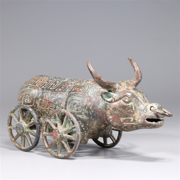 Appraisal: Chinese archaistic bronze model of a bull on wheels with