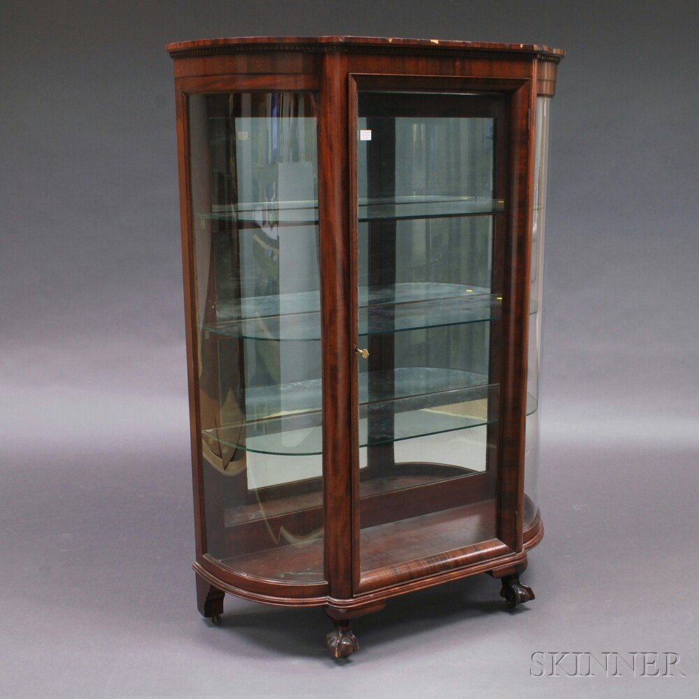 Appraisal: Mahogany Veneer Glazed Cabinet the dentil-molded top and conforming case