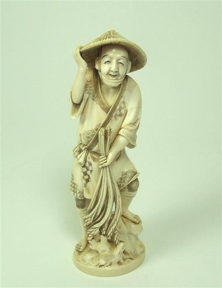 Appraisal: A Japanese ivory figure of a peasant Meiji or Taisho