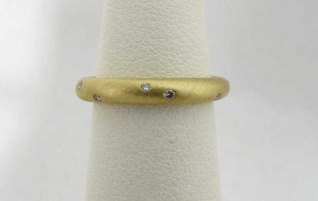 Appraisal: k yellow gold flush set diamond band rounded shape ring