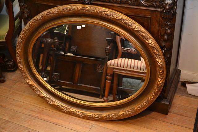 Appraisal: A LARGE CLASSICAL GILT OVAL MIRROR WITH BEVELLED EDGE