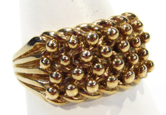 Appraisal: A textured gentleman's dress ring on part pierced shank yellow