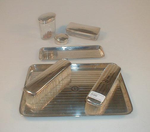 Appraisal: A silver seven piece dressing table set engine turned and