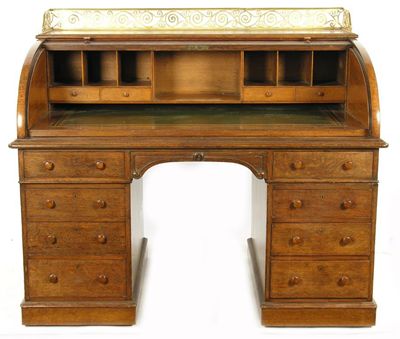 Appraisal: A late Victorian oak cylinder bureau the pierced brass three