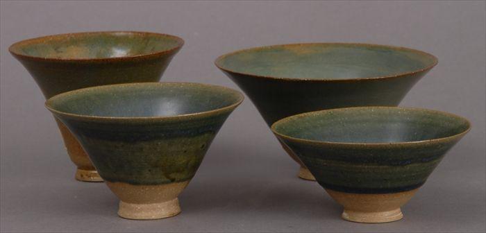 Appraisal: FOUR TH C GREEN-GLAZED POTTERY BELL-FORM FOOTED BOWLS to x