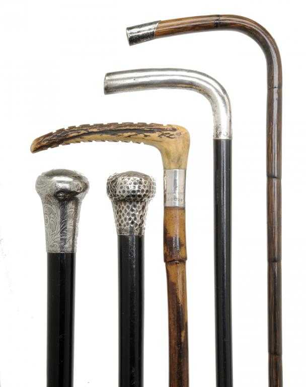 Appraisal: FOUR SILVER-MOUNTED CANES AND A WHIP of ebony and bamboo