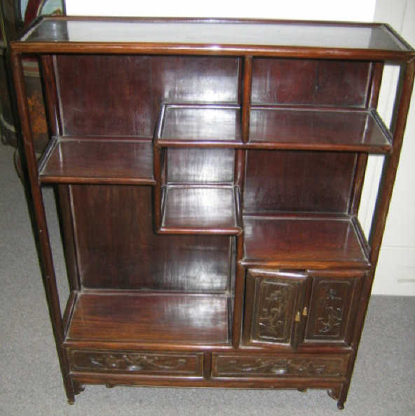 Appraisal: ASIAN HARDWOOD SHELF Showing an assortment of open shelves a