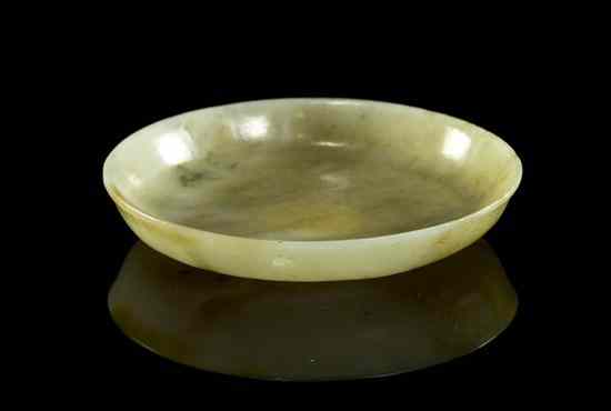 Appraisal: A Chinese Jade Saucer of a light celadon and russet