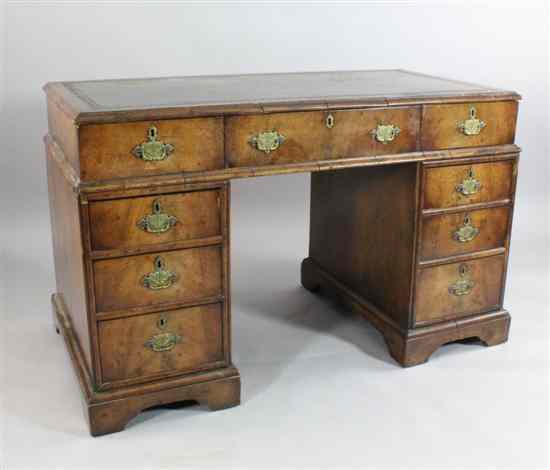 Appraisal: A late Victorian walnut pedestal desk with nine drawers on