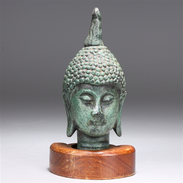 Appraisal: Thai bronze Buddha head with a green patina downcast eyes