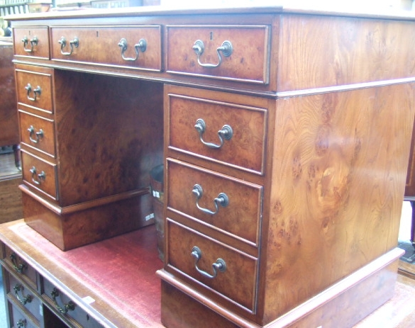 Appraisal: A reproduction walnut pedestal desk the gilt tooled brown leather