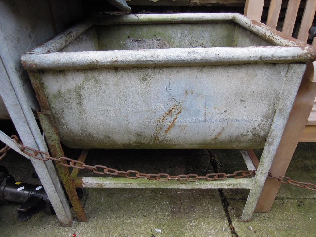 Appraisal: Two galvanised feeding troughs raised on angle iron supports