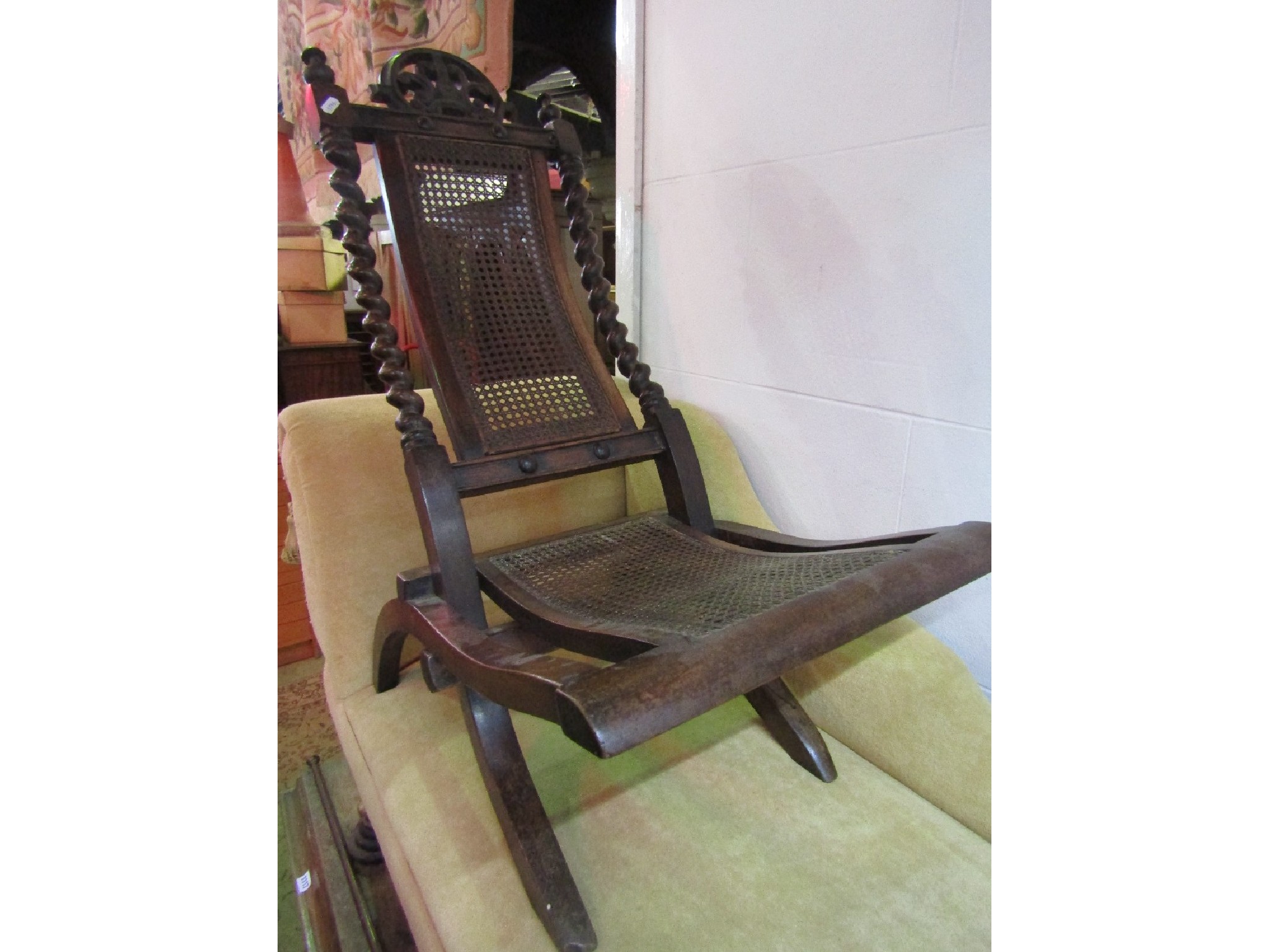 Appraisal: A low seated Victorian folding chair with cane panelled seat